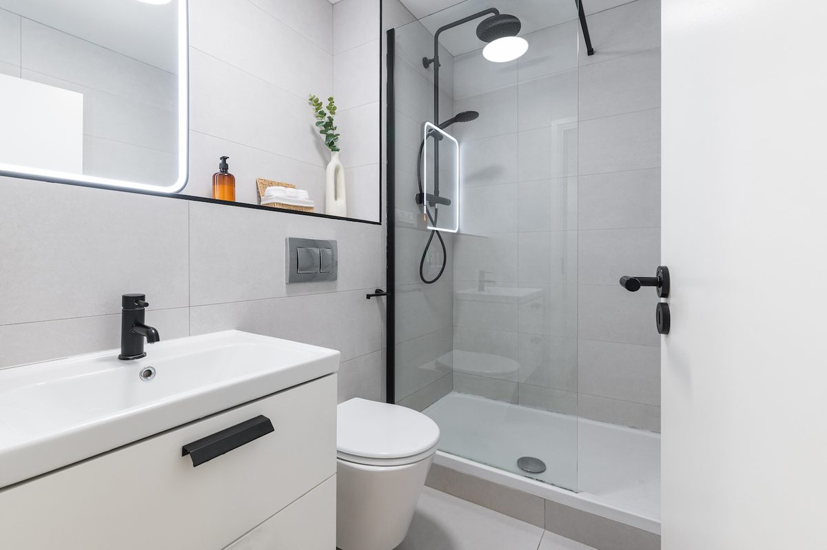 Modern walk-in shower room with rainfall head, vanity unit and WC in EirStay Islandbridge serviced apartment Dublin 8