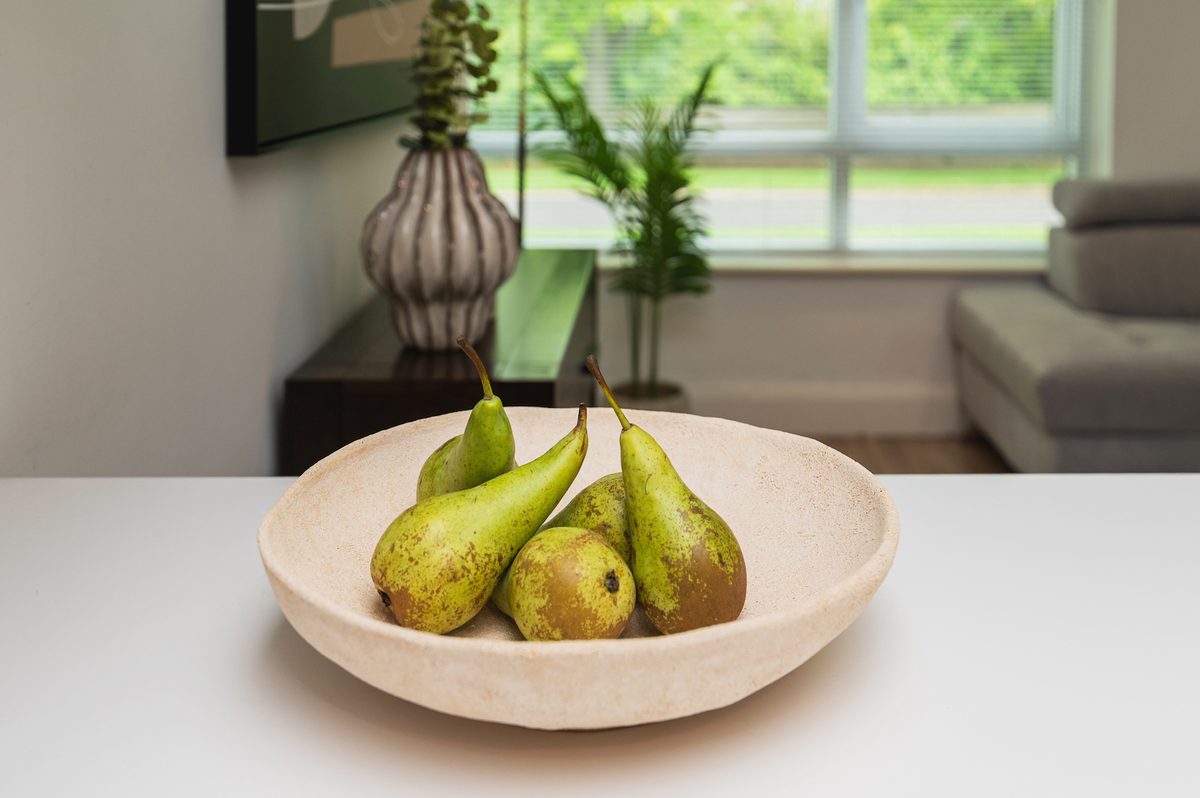 Bowl of fresh pears on the kitchen counter — a considered welcome touch at EirStay Islandbridge serviced apartment Dublin 8
